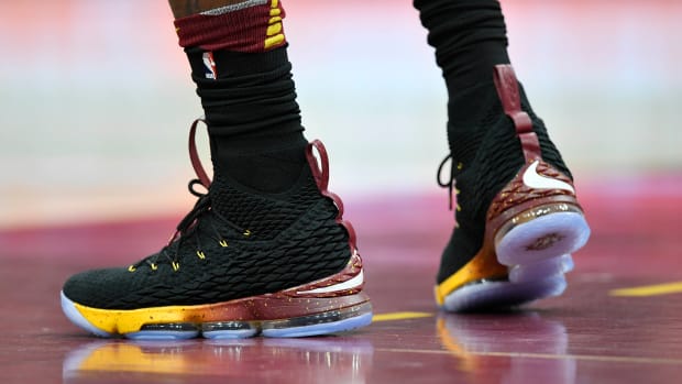 View of black and gold Nike LeBron shoes.